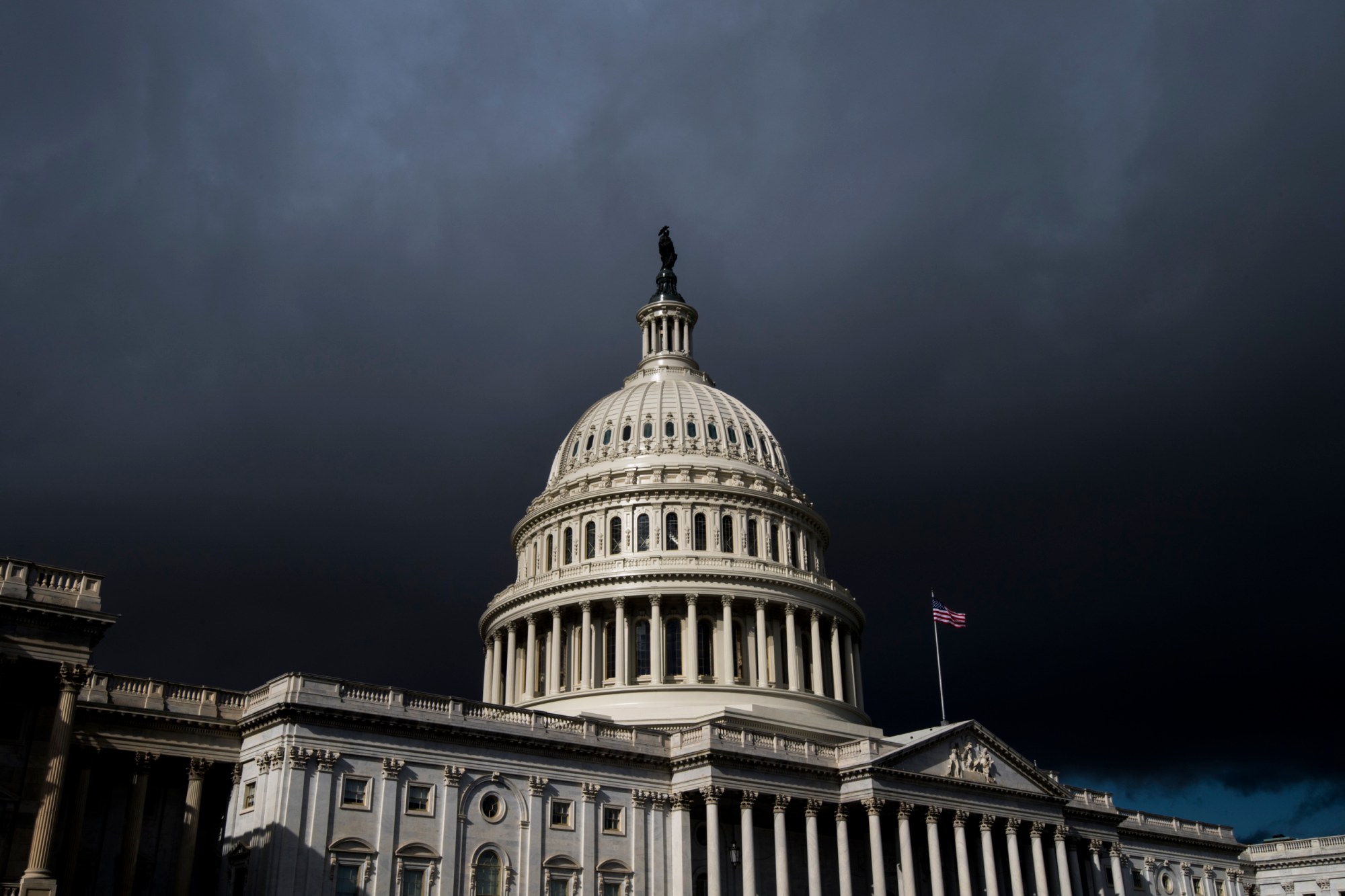 Storm clouds pass over the dome of the U.S. Capitol building, January 2018. (Getty/Bill Clark)