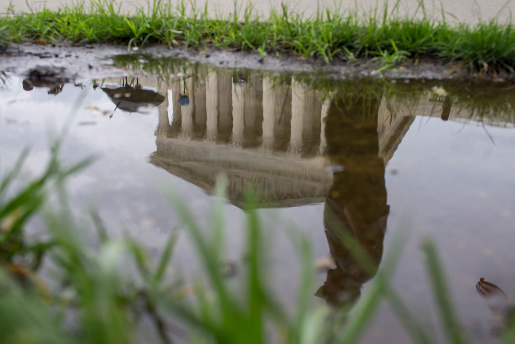 The U.S. Supreme Court is reflected in a puddle, June 27, 2018. (Getty/Zach Gibson)