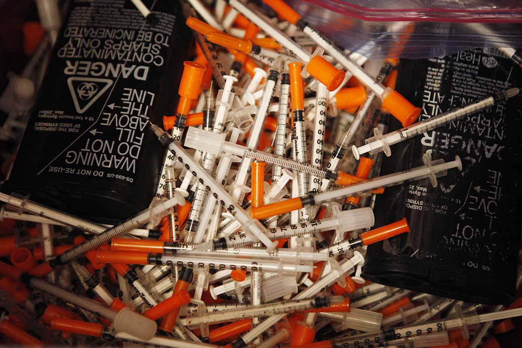 Used hypodermic needles are seen in a bin, July 2, 2015, at a Maine public health center's needle exchange. (Getty/Portland Press Herald/Joel Page)