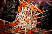 Used hypodermic needles are seen in a bin, July 2, 2015, at a Maine public health center's needle exchange. (Getty/Portland Press Herald/Joel Page)