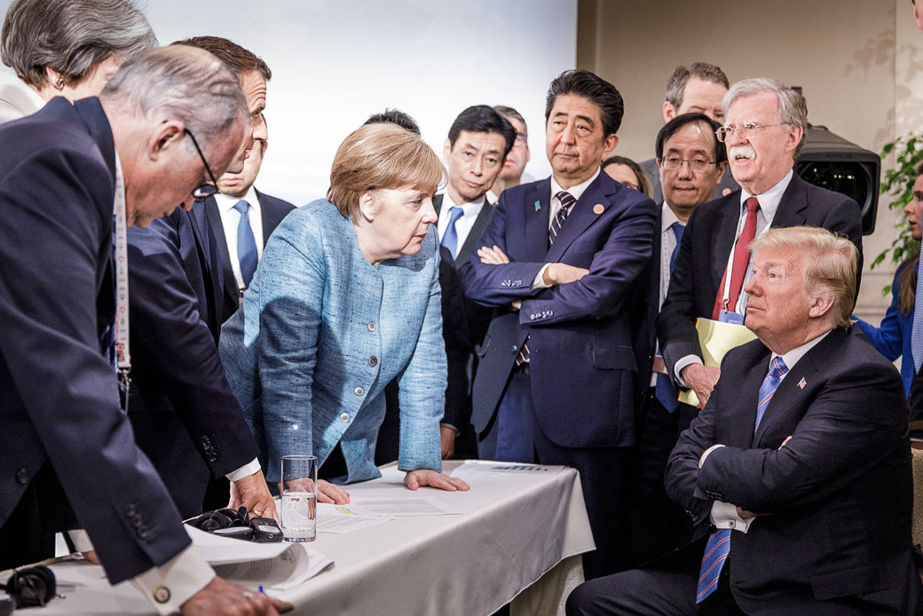 U.S. President Donald Trump deliberates with German Chancellor Angela Merkel and other foreign leaders on the second day of the G-7 summit in Charlevoix, Canada, June 9, 2018. (Getty/Bundesregierung/Jesco Denzel)