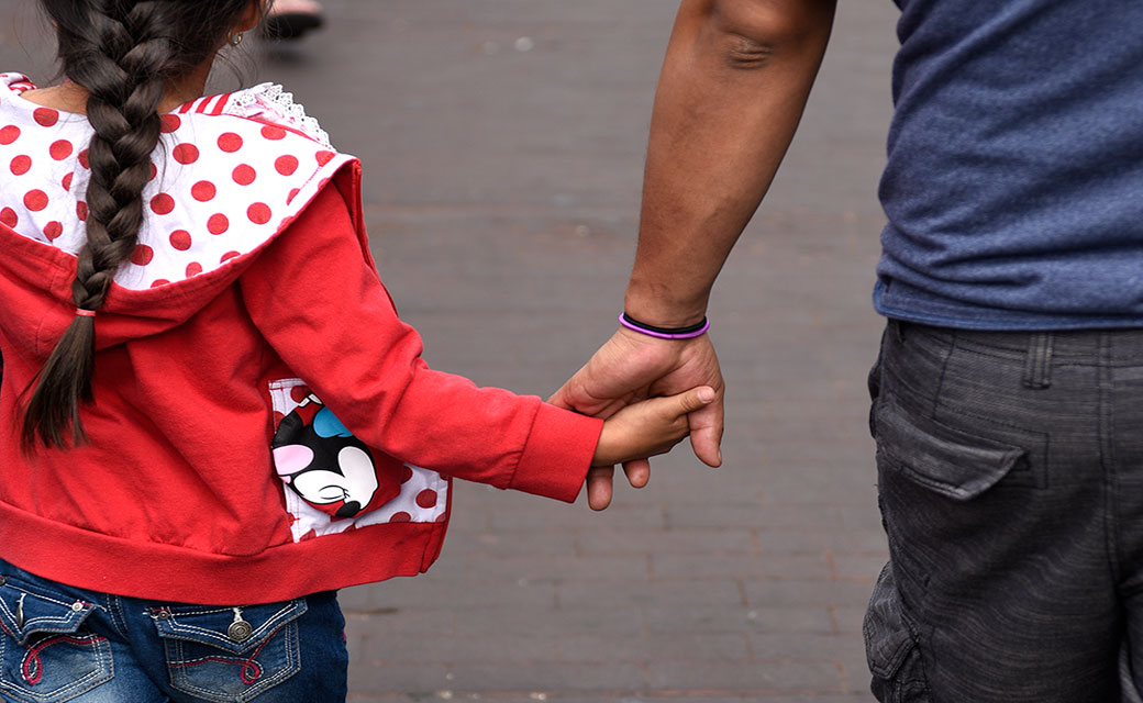 A father walks hand in hand with his daughter in Santa Fe, New Mexico. (Getty/Robert Alexander)