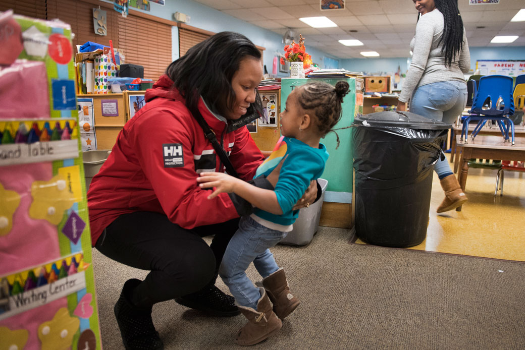 Single mother Monique Burton picks up her daughter from a children's day care center in Greenbelt, Maryland. At the time, Burton was working toward her associate degree, December 2016. (Getty/The Washington Post/Linda Davidson)