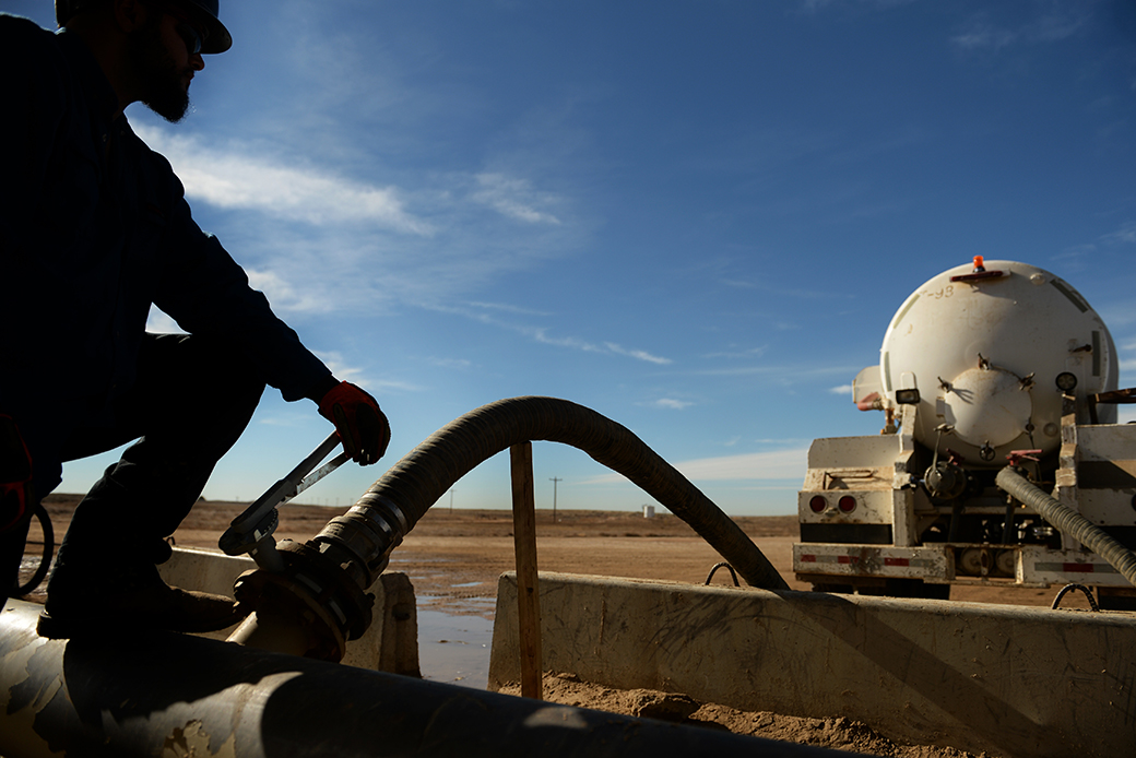 A man fills his water truck so he can do dust control on the road in an oil and gas lease in Colorado, October 2014. (Getty/The Denver Post/RJ Sangosti)