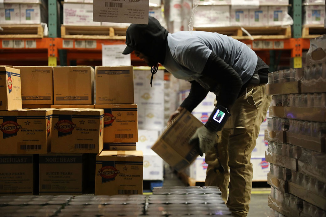 A worker moves pallets of food in New York City, June 2017. (Getty/Spencer Platt)