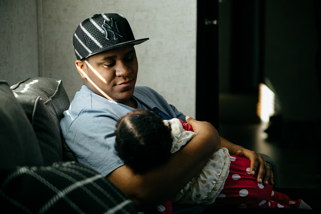 A transgender father holds his 1-year-old daughter on her birthday, March 2017, in Michigan. (Getty/JJ Fabre)