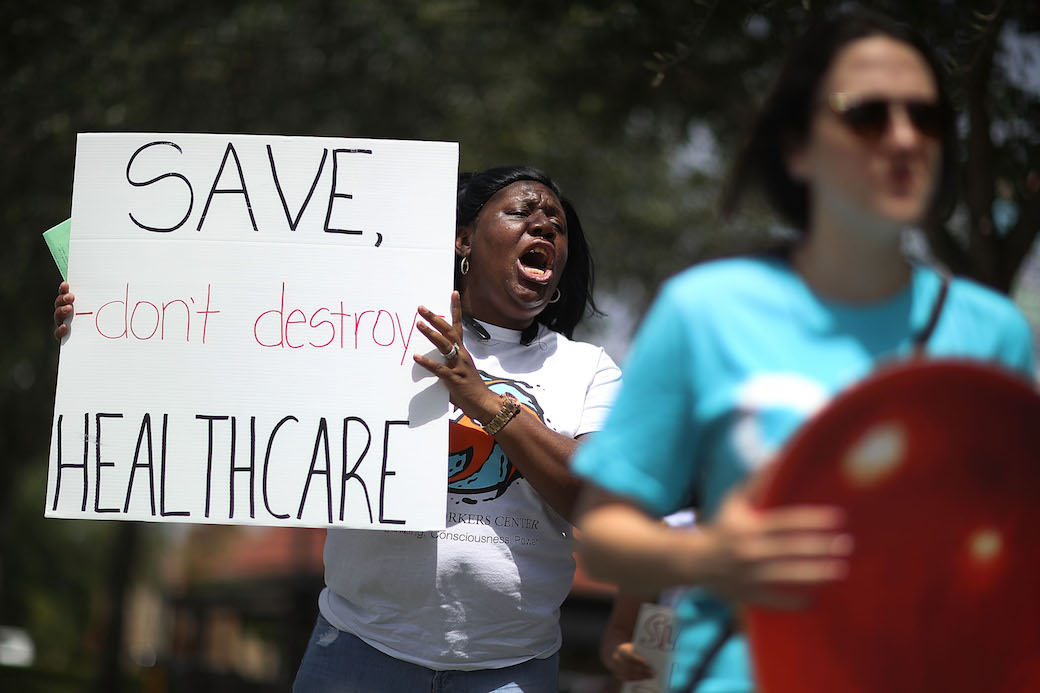 Protesters gather in front of the office of Rep. Carlos Curbelo (R-FL) to ask him to explain his vote on the Affordable Care Act, Miami, Florida, August 2017. (Getty/Joe Raedle)