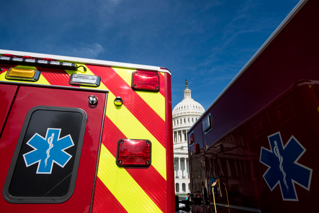 The U.S. Capitol Building is seen behind two ambulances, June 2018. (Getty/Bill Clark)