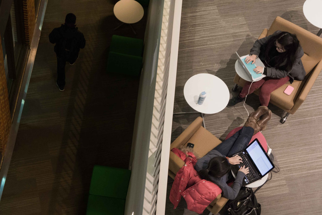 Two college students study on their laptops in a university library in Baltimore, Maryland, January 2013. (Getty/Gado/JHU Sheridan Libraries)