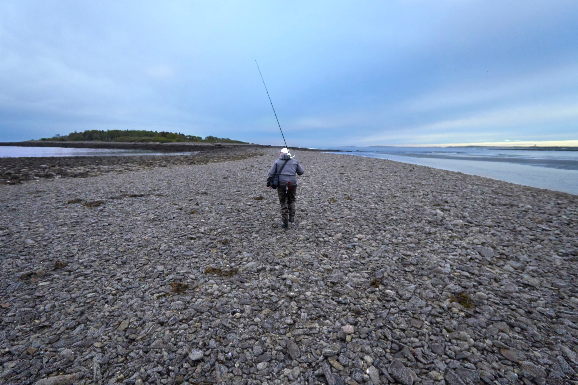 KENNEBUNKPORT, ME - JUNE 9: Paul Korenkiewicz walks across a rock bar while fishing for stripers off the coast of Kennebunkport on Friday, June 9, 2017. (Staff Photo by Gregory Rec/Portland Press Herald via Getty Images)