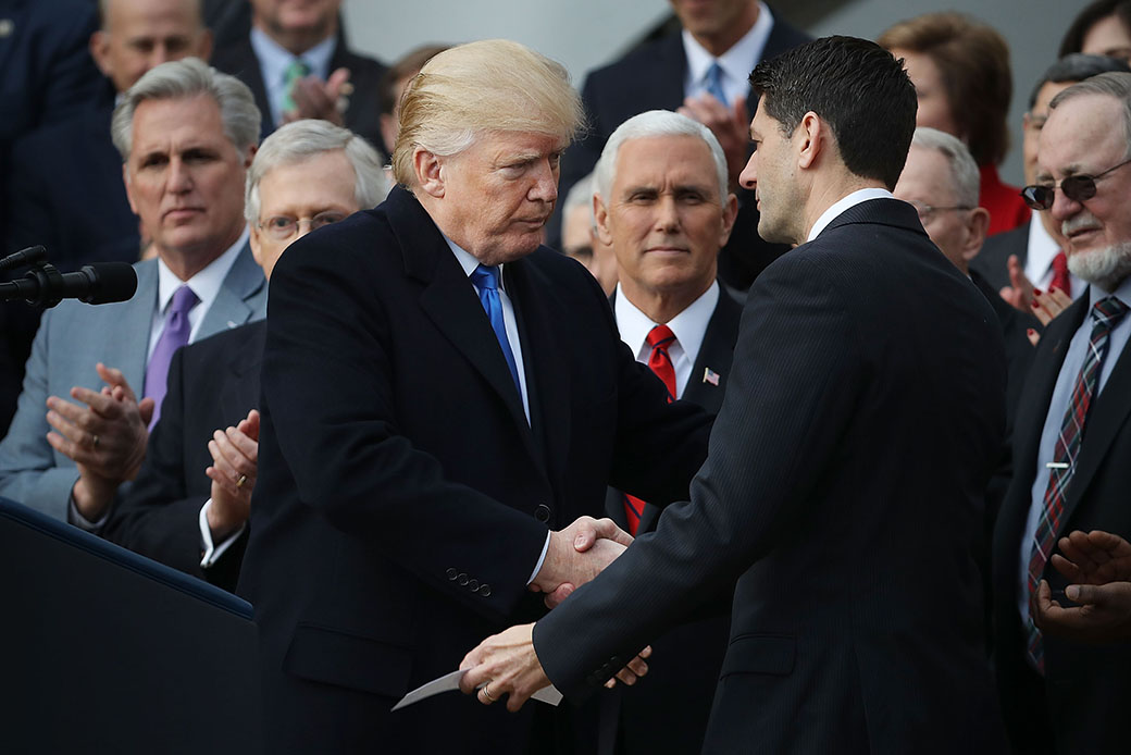 President Donald Trump congratulates Speaker of the House Paul Ryan (R-WI) during an event to celebrate Congress passing the Tax Cuts and Jobs Act on the South Lawn of the White House, December 20, 2017, in Washington. (Getty/Chip Somodevilla)