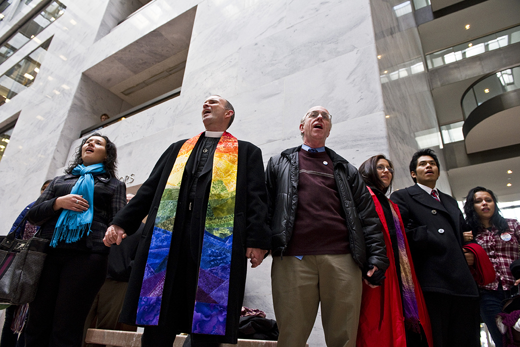 A reverend of a Unitarian Universalist church in Massachusetts leads a song with other participants rallying in support of the DREAM Act. Unitarian Universalist leaders are just some of the people and organizations of faith who have signed on to support LGBTQ equality in a Philadelphia child welfare case. (Getty/Scott J. Ferrell)