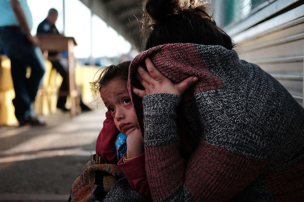A mother and daughter wait along the border bridge after being denied entry from Mexico into the United States, Brownsville, Texas, June 2018. (Getty/Spencer Platt)
