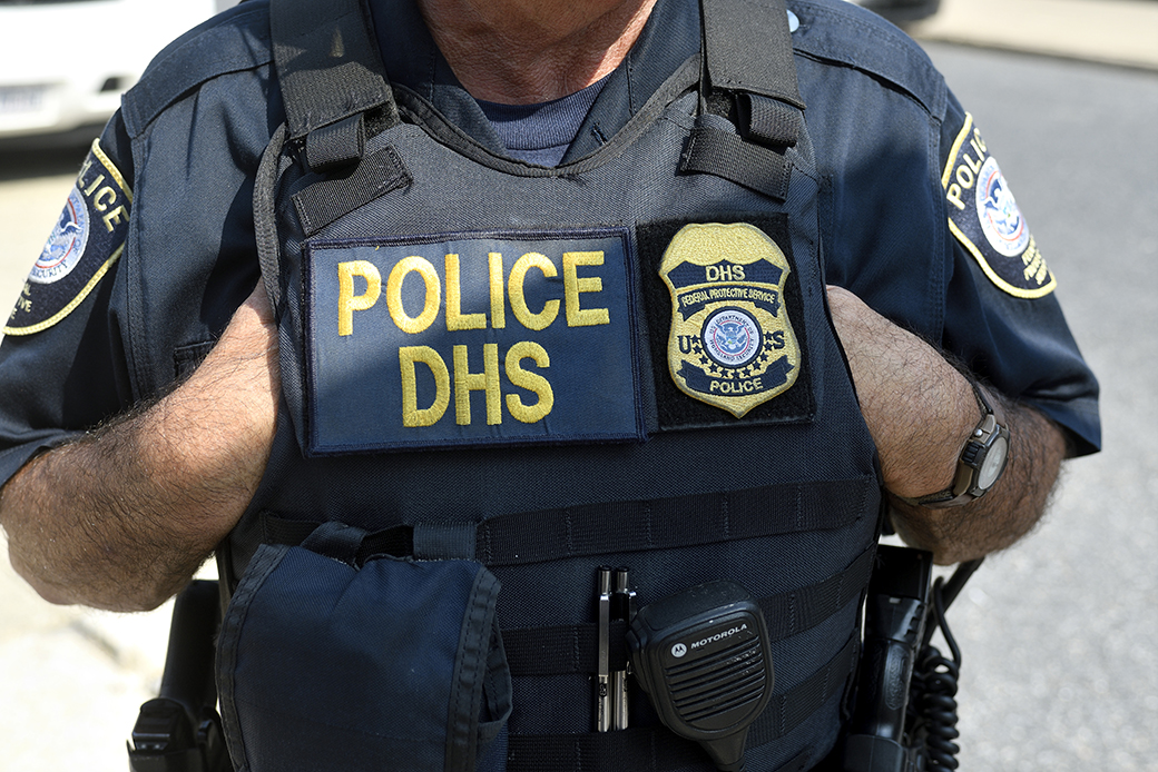 Law enforcement officers of the Philadelphia Police Department, Homeland Security, and National Park Service stand by as protestors build a small encampment outside a Department of Homeland Security U.S. Immigration and Customs Enforcement office in Pennsylvania, July 2018. (Getty/Bastiaan Slabbers)