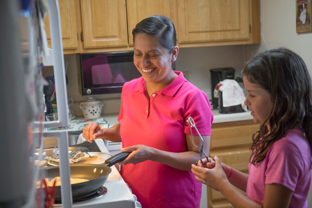 A mother cooks with her 8-year-old daughter in Ames, Iowa. (Getty/The Washington Post/Rachel Mummey)