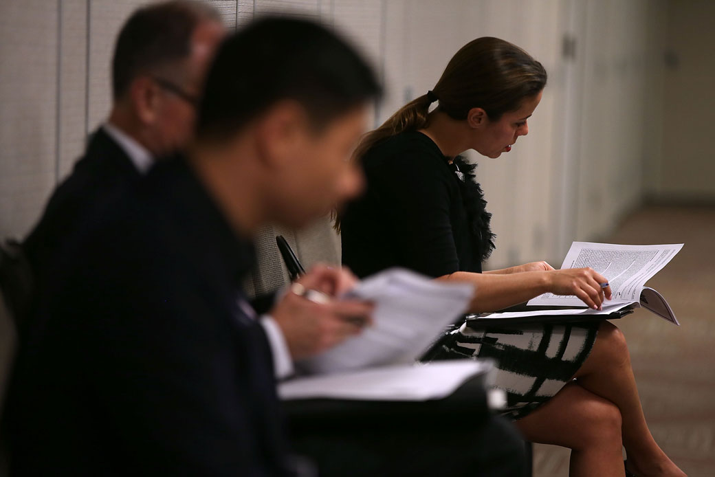 Job seekers fill out registration forms before entering a career fair in San Francisco, June 2015. (Getty/Justin Sullivan)