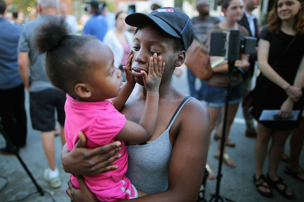 A mother holds her 2-year-old daughter in Charleston, South Carolina. (Getty/Chip Somodevilla)