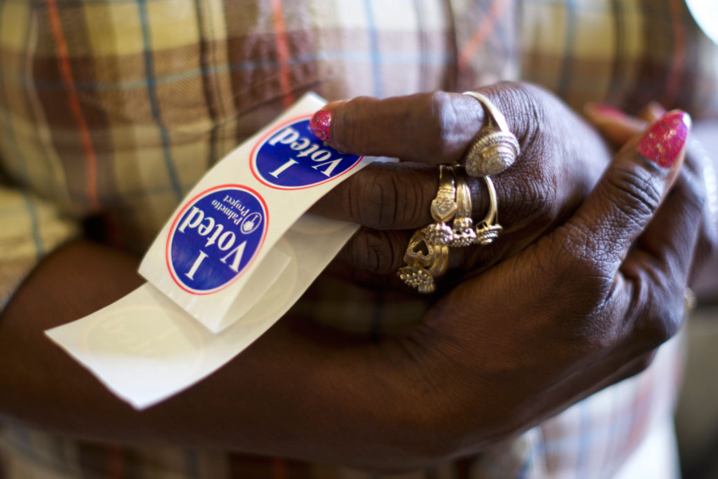 A poll station official holds 