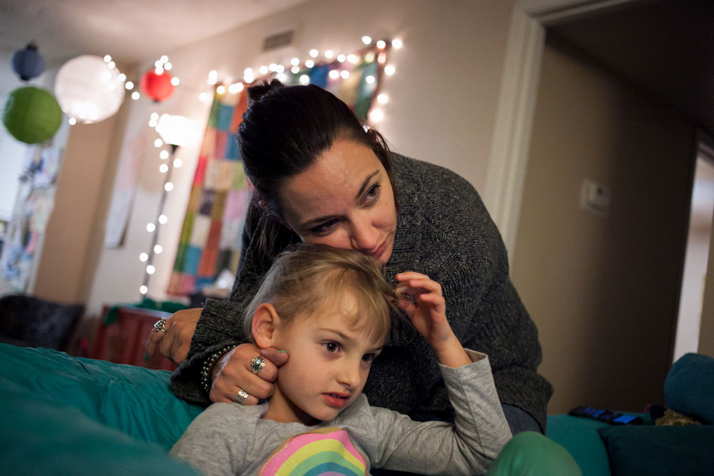 A mother leans on her 5-year-old daughter at their family home, February 2015. (Getty/The Washington Post/Ilana Panich-Linsman)