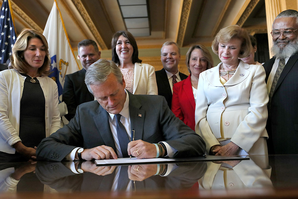 Massachusetts Gov. Charlie Baker (R) signs legislation repealing the state's archaic anti-abortion laws on July 27, 2018. (Getty/The Boston Globe/Suzanne Kreiter)