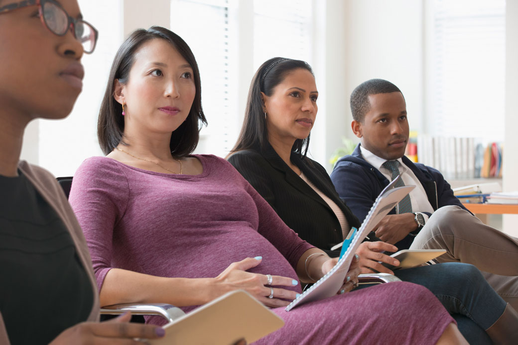 A group of people sit and take notes in an office. (Getty/Jose Luis Pelaez Inc.)