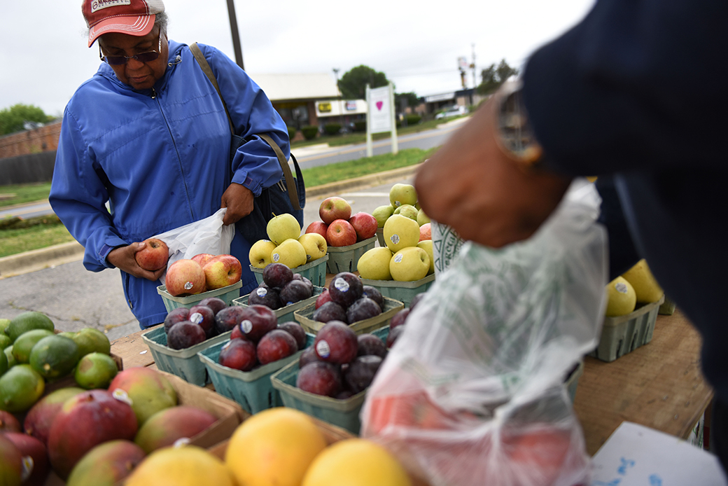 A woman shops for fresh produce at a farmer's market in Temple Hills, Maryland, an area designated as a food desert, May 2016. (Getty/Michael Robinson Chavez)