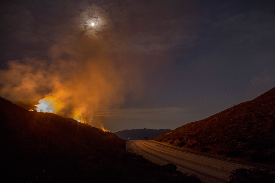 The 210 freeway remains closed as flames continue to spread under moonlight, September 2017. (Getty/David McNew)