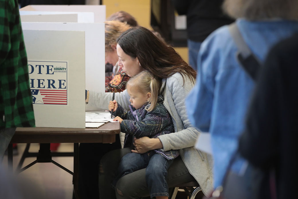 A voter holds her 2-year-old daughter while at a polling place in Kirkwood, Missouri, on November 6, 2018. (Getty/Scott Olson)