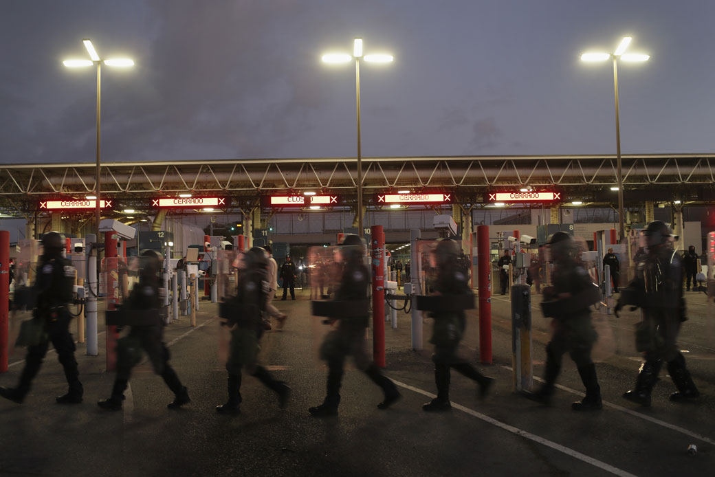 U.S. Customs and Border Protection officers block the Otay Mesa port of entry on December 1, 2018, seen here from Tijuana, Mexico. (Getty/John Moore)