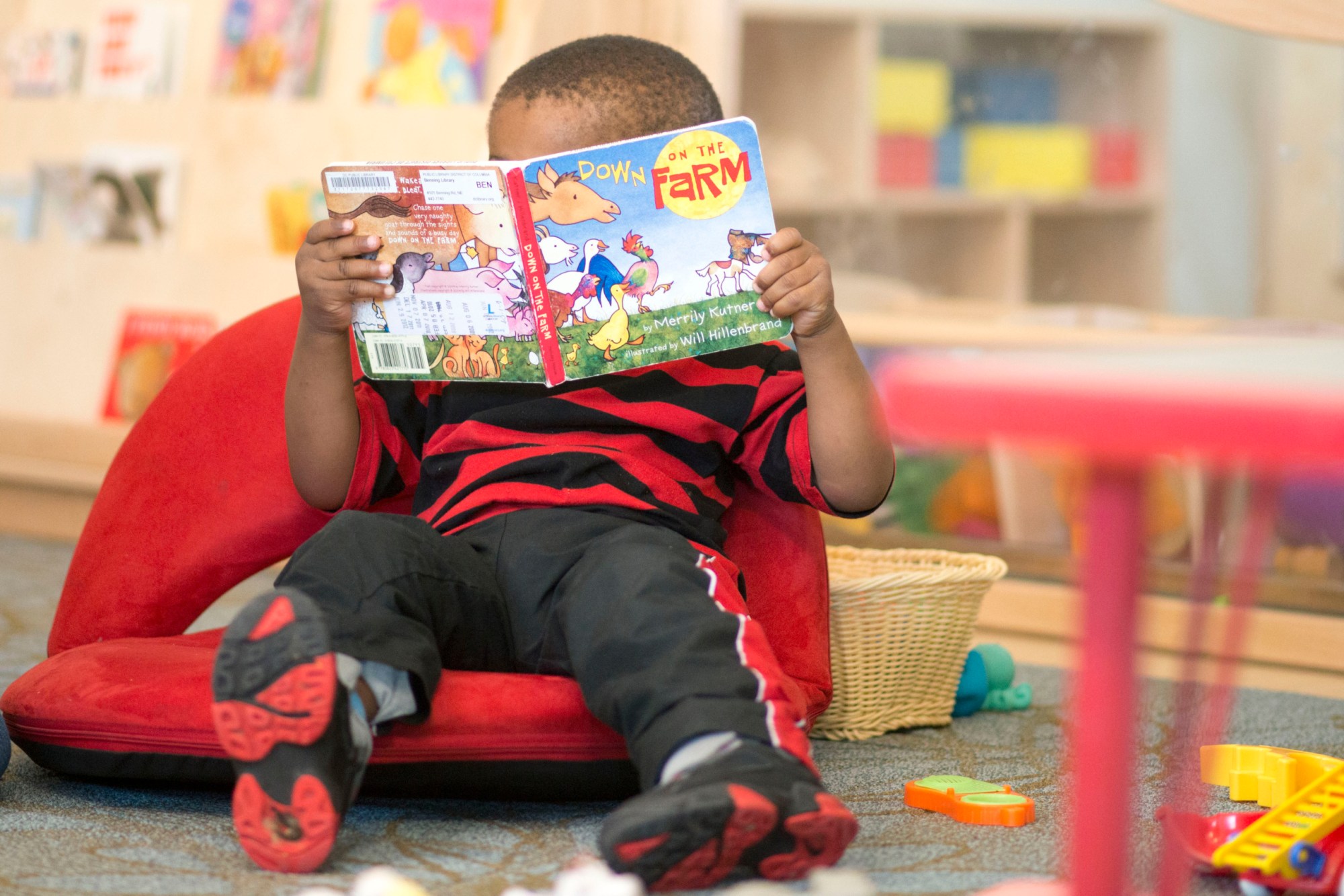 WASHINGTON-DC: JUNE 10
  Eliarjiah Hargrove, 2 reading Merrily Kutner's book  Down on the Farm at Educare in Washington, D.C. on June 10, 2013.Educare in Washington, D.C. on June 10, 2013.
Photos for a story about this preschool in Anacostia that will be a model for the country. It is marking its first anniversary in DC at a time when President Obama has made early childhood education a major priority for his second term. Education Secretary Arne Duncan and HHS Secretary Kathleen Sebelius will be touring it on Wednesday
(Photo by Marvin Joseph/The Washington Post via Getty Images)