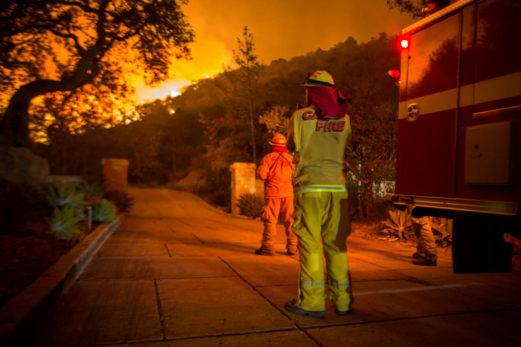 Firefighters watch as the Thomas Fire approaches homes in December 2017, in Montecito, California. (Getty/David McNew)