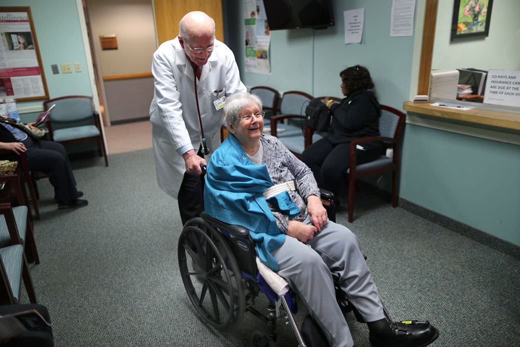 A doctor in Milton, Massachusetts, wheels his patient into his office, February 2018. (Getty/John Tlumacki)