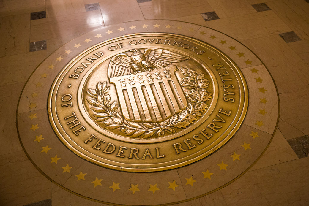 Light reflects off a gold-plated seal inside the Marriner S. Eccles Federal Reserve Board Building in Washington, D.C. (Getty/Brooks Kraft)
