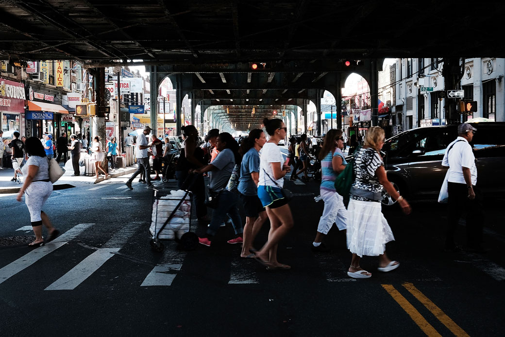 People walk through a neighborhood in Queens, New York, on August 29, 2016. (Getty/Spencer Platt)