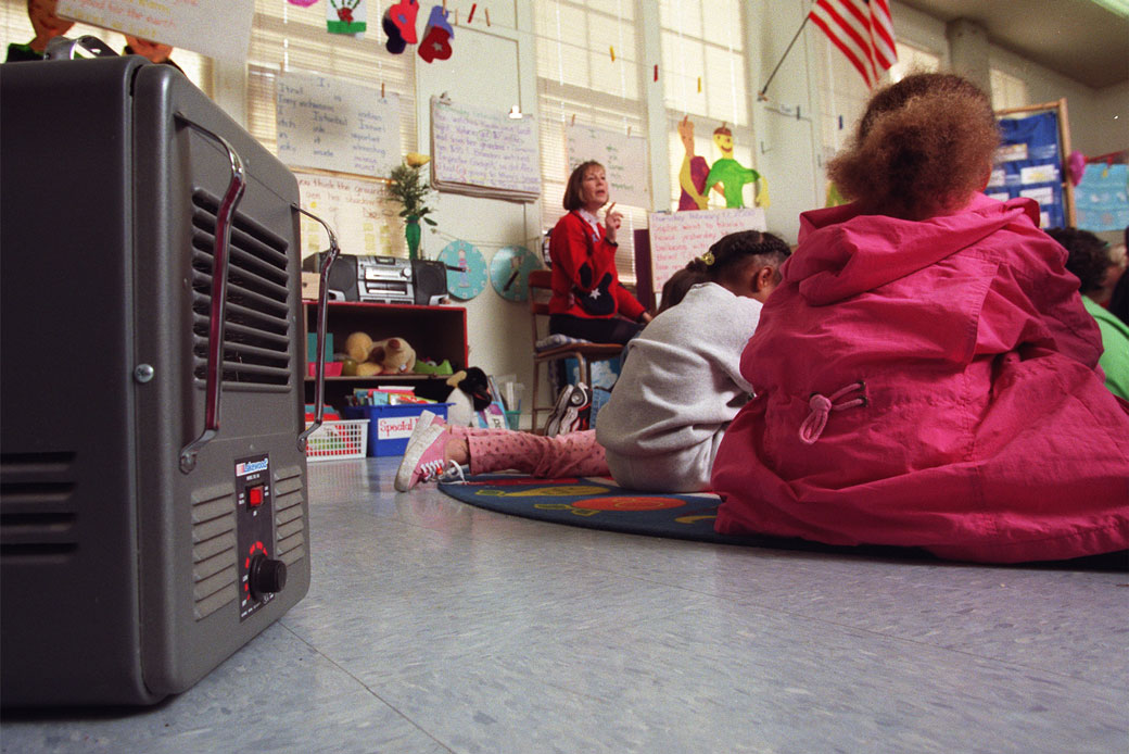 A kindergarten teacher in Los Angeles uses an electric heater for her classroom; the school's air conditioning and heating system has been out of service for more than a year. (Getty/Rick Meyer)