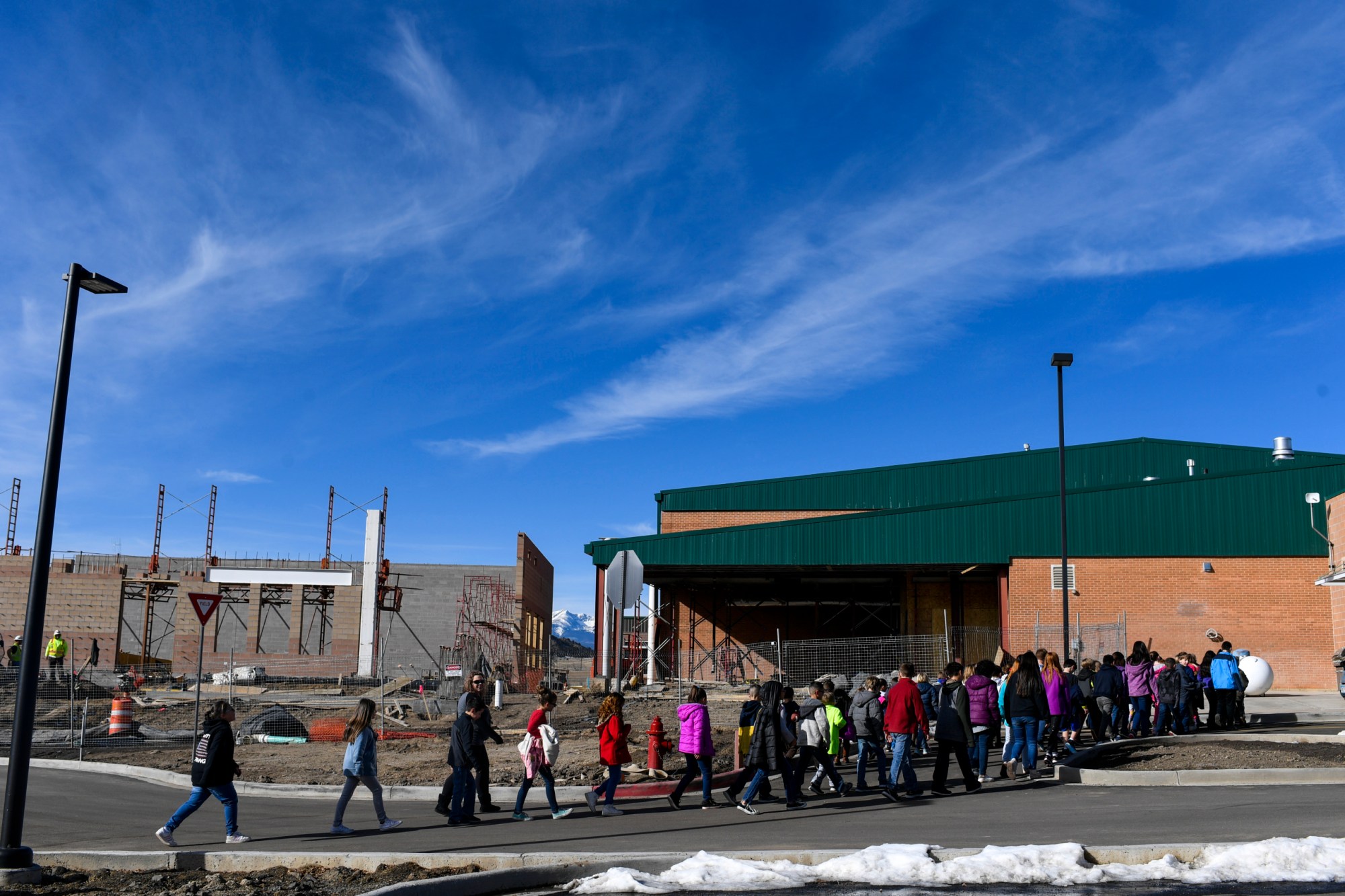 Students walk back to class as construction crews work on the wellness center and gymnasium additions at Primero school in Weston, CO. (Getty/AAron Ontiveroz)