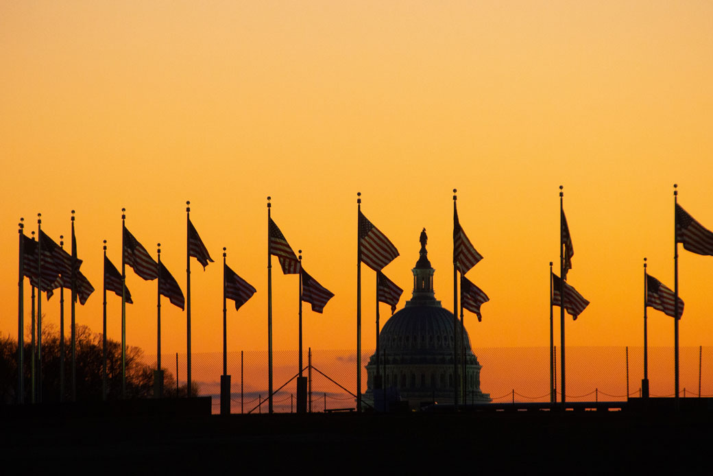 The sun rises behind the U.S. Capitol in Washington, D.C., January 2019. (Getty/Adam Gray)