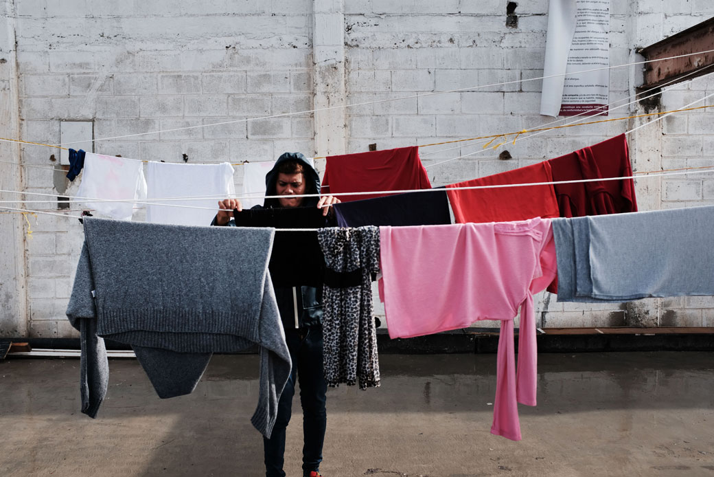 A member of the migrant caravan does laundry inside a migrant shelter in Tijuana, Mexico, January 2019. (Getty/Spencer Platt)