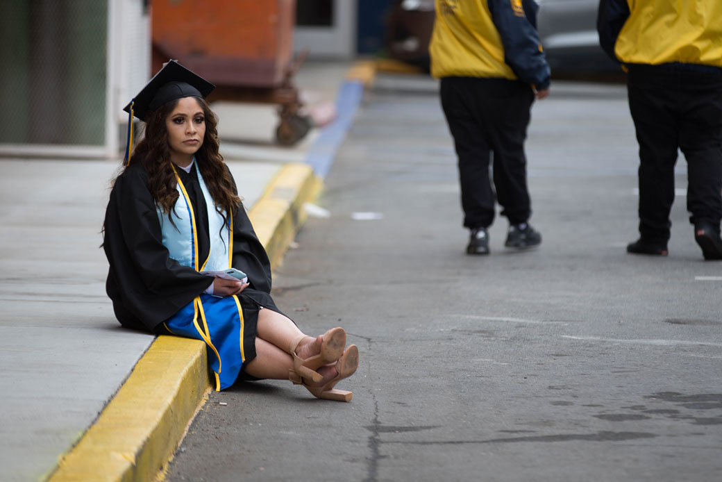 A college student waits for her commencement ceremony to begin in San Jose, California, on December 19, 2018. (Getty/The Mercury News/Randy Vazquez)