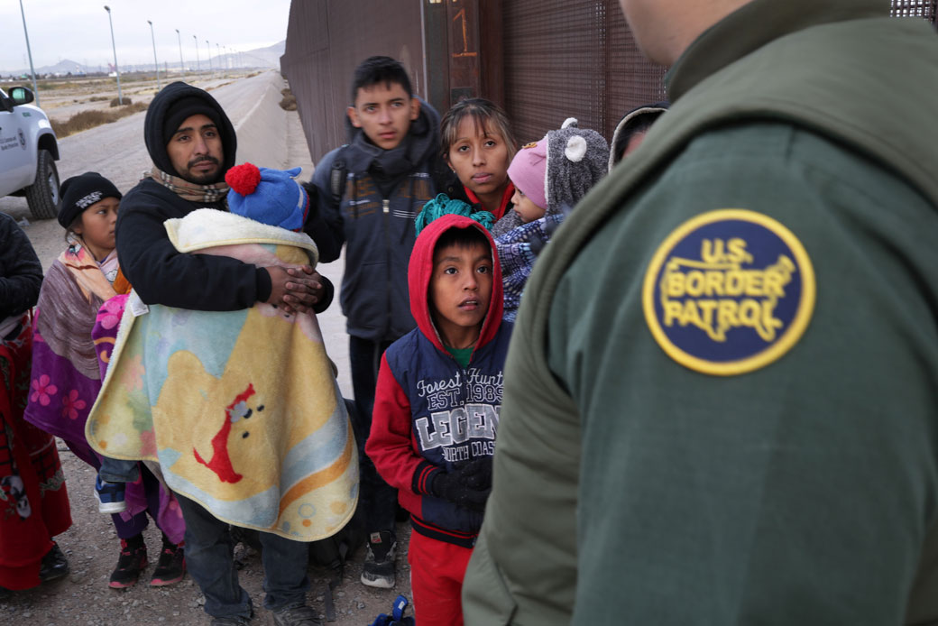A Border Patrol agent speaks with immigrants at the U.S.-Mexico border in El Paso, Texas, February 2019. (Getty/John Moore)