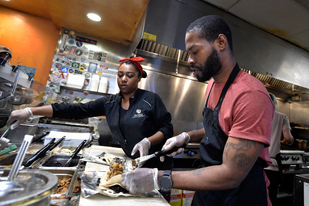 Employees at a fast-food restaurant in Boulder, Colorado, prepare food for customers. (Getty/Daily Camera/Jeremy Papasso)