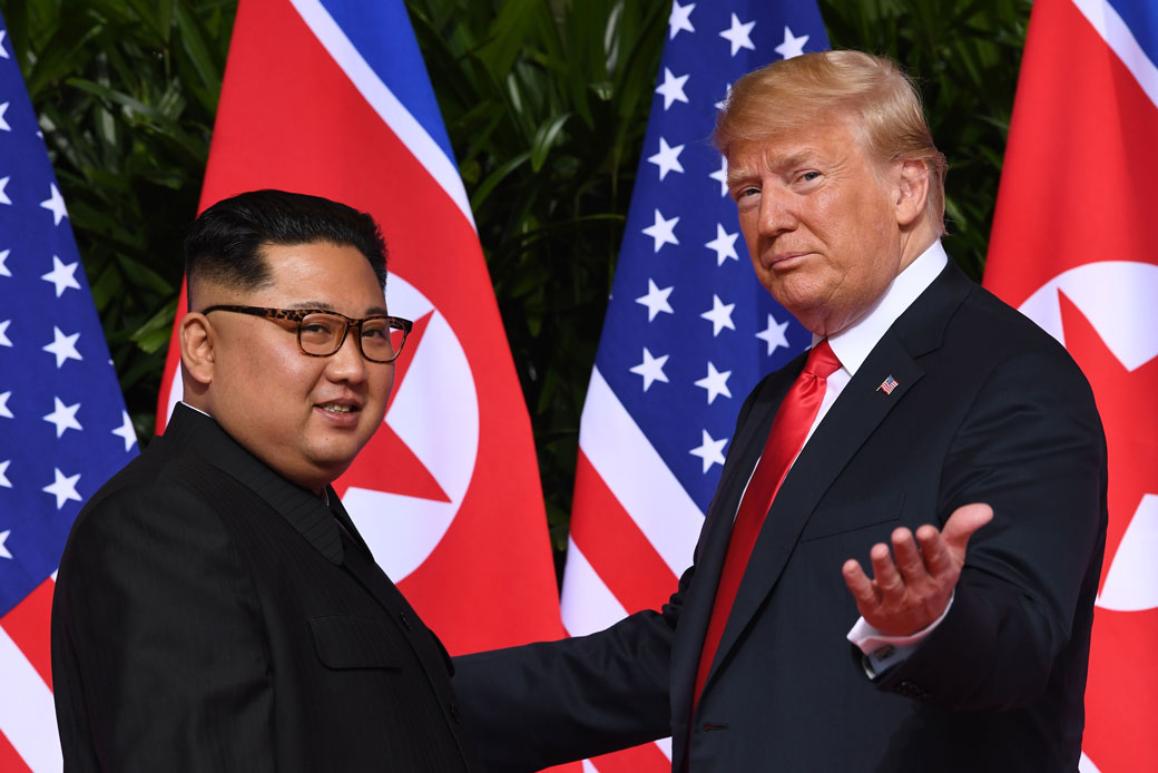 U.S. President Donald Trump gestures as he meets with North Korean leader Kim Jong Un at the start of their historic summit in Singapore on June 12, 2018. (Getty/AFP/Saul Loeb)