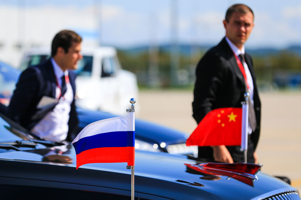 A motorcade car adorned with Chinese and Russian flags sits idle at Vladivostok International Airport, Russia, on September 11, 2018. (Getty/TASS/Vladimir Smirnov)