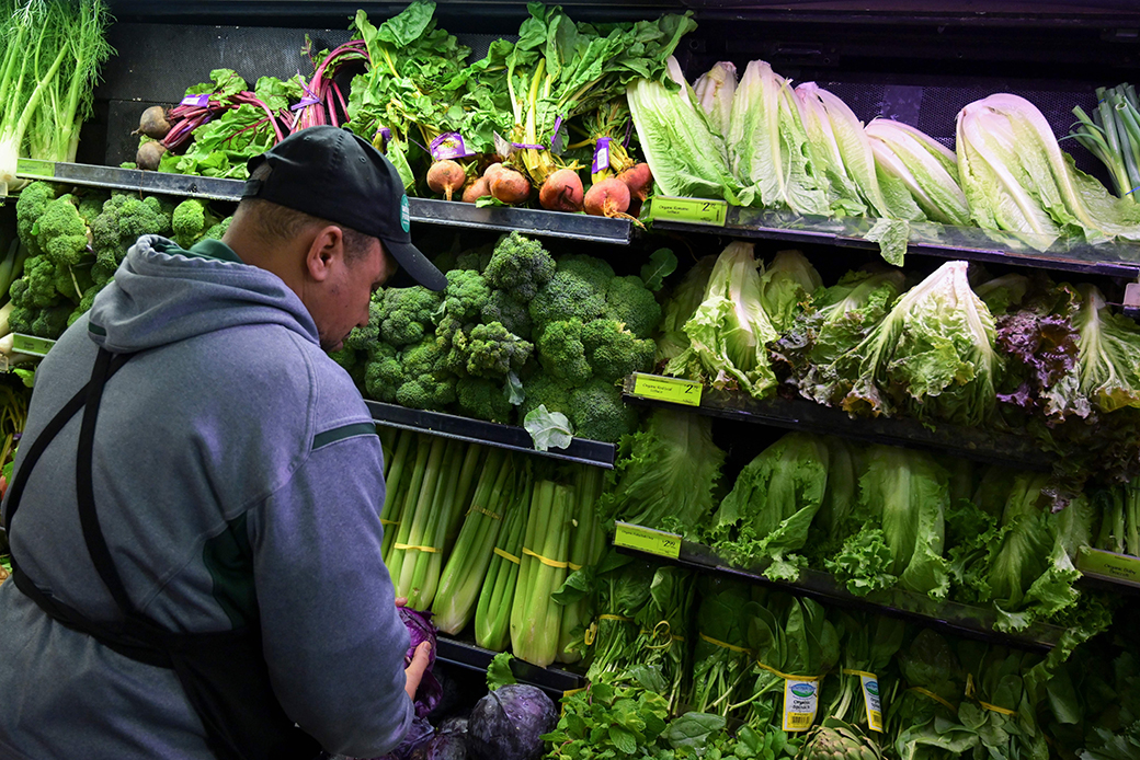A produce worker stocks shelves at a supermarket in Washington, D.C., on November 2018. (Getty/Andrew Caballero-Reynolds)