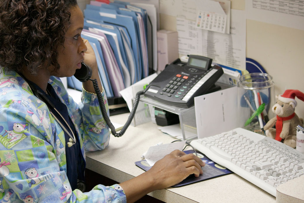 A medical assistant at Mount Sinai Medical Center in Miami speaks on the phone, April 2008. (Getty/UIG/Jeff Greenberg)