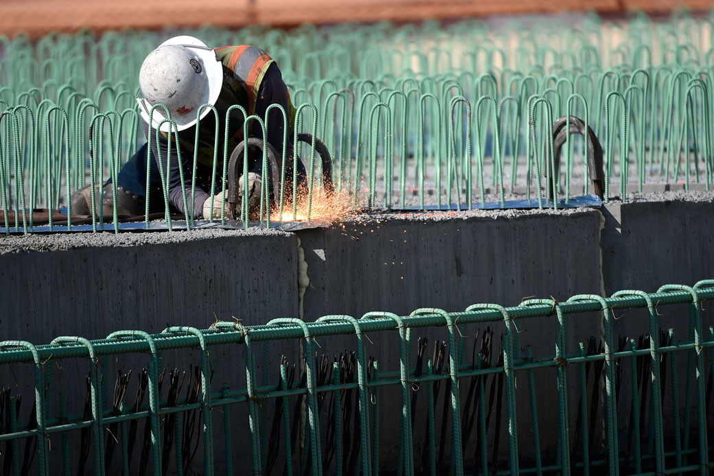 A construction worker uses a blowtorch on an interchange bridge in Englewood, Colorado, August 2016. (Getty/The Denver Post/Seth McConnell)