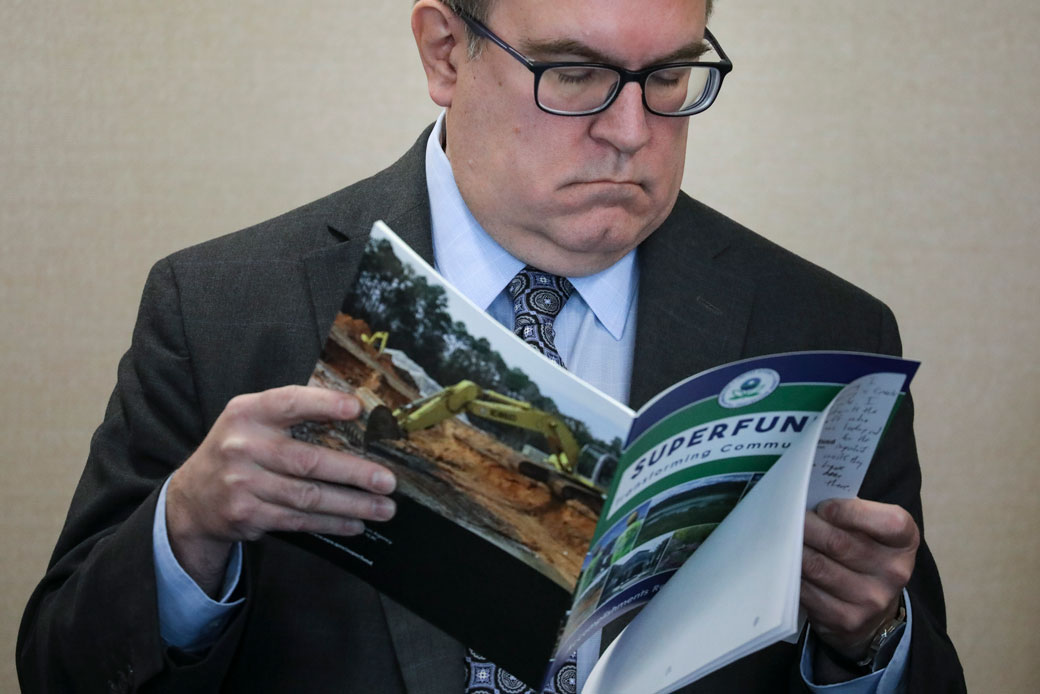 Environmental Protection Agency (EPA) Administrator Andrew Wheeler looks at a pamphlet about Superfund sites, March 2019. (Getty/Drew Angerer)