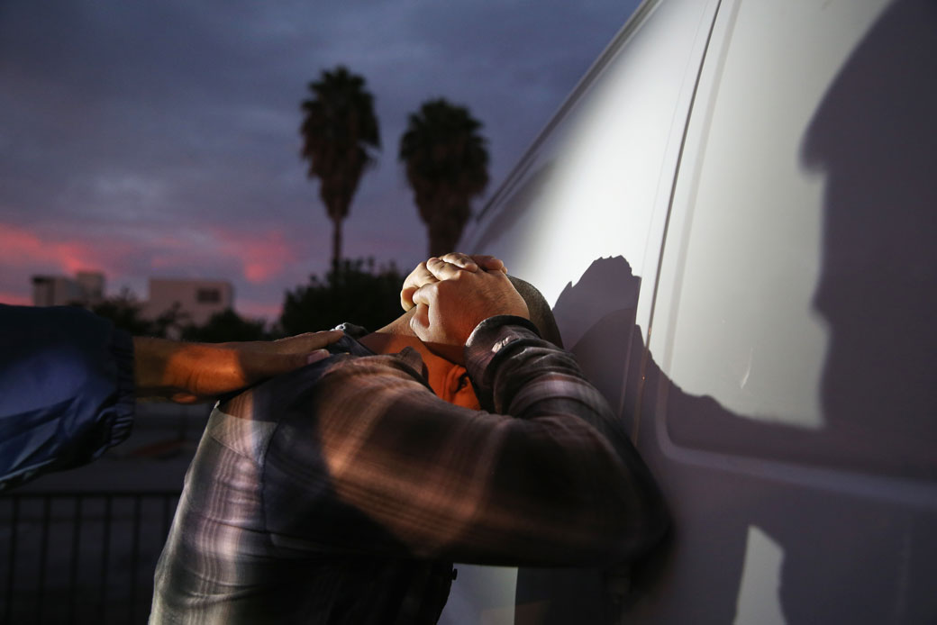 A man is detained by U.S. Immigration and Customs Enforcement agents in Los Angeles, October 2015. (Getty/John Moore)