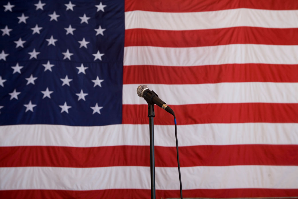 An American flag and microphone on stage, February 2008.