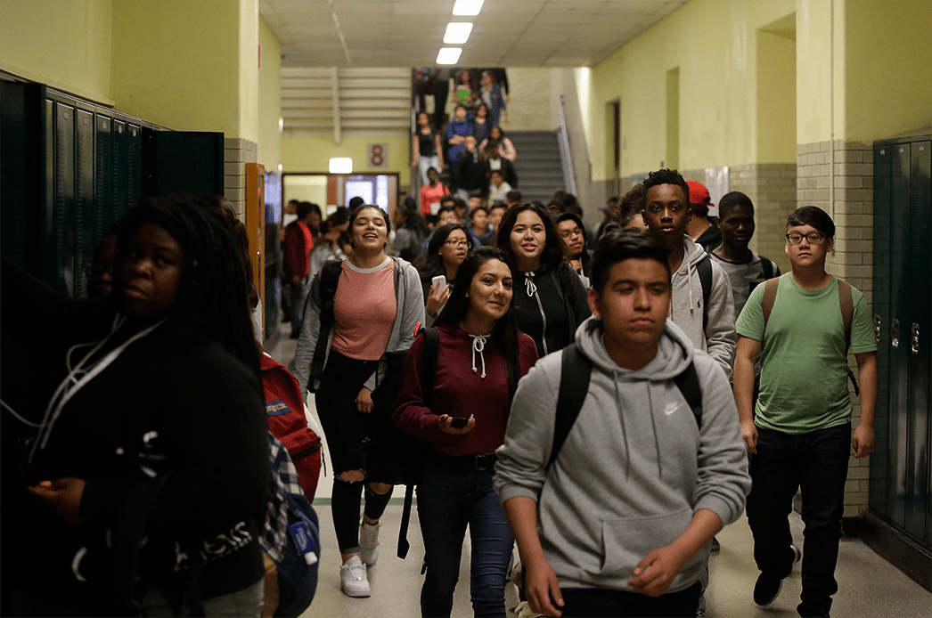 Students walk through the hallway after classes were dismissed at Senn High School on May 10, 2017. (Getty/ Joshua Lott)